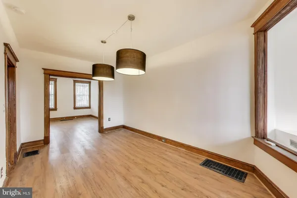 a view of room with window and wooden floor