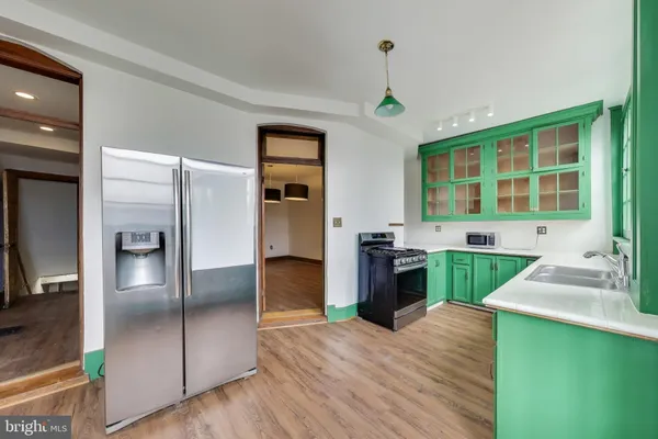 a kitchen with a refrigerator a sink and cabinets