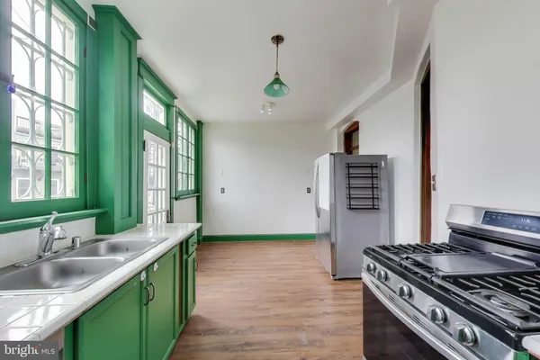 a kitchen with stainless steel appliances granite countertop a sink stove and cabinets