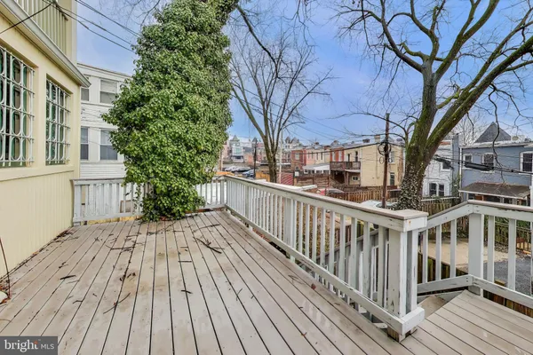 a view of a balcony with wooden floor and fence