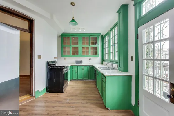 a kitchen with a sink and a stove top oven