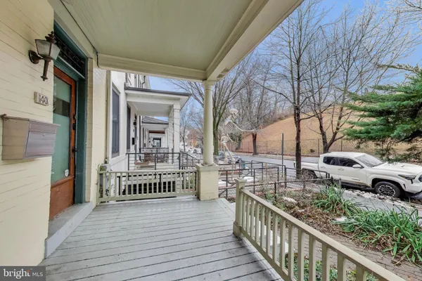 a view of a house with barbeque and outdoor seating
