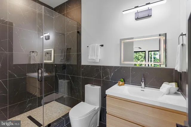 a bathroom with a white tub shower and window