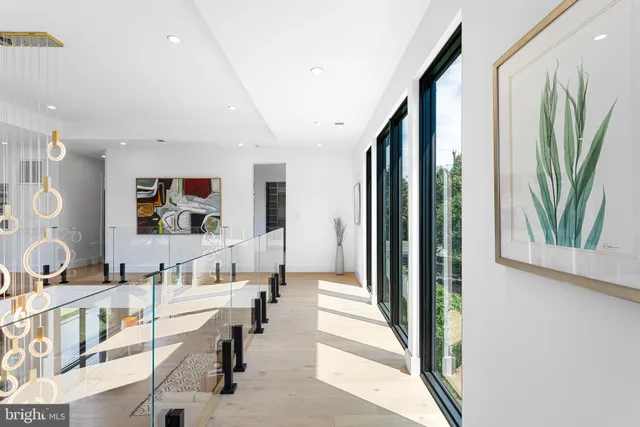 a living room with furniture and large windows