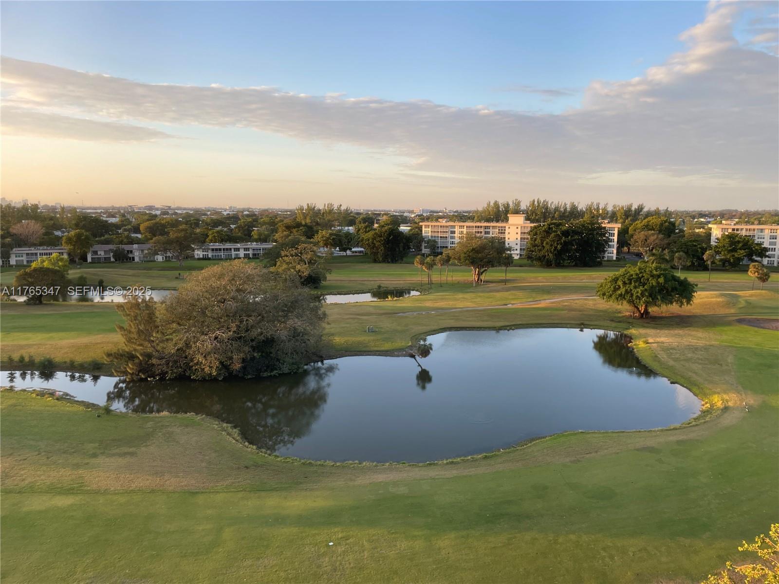 2681 South Course Drive, Unit 912 Pompano Beach, FL 33069 - Photo 16 of 44 a view of a lake with a yard