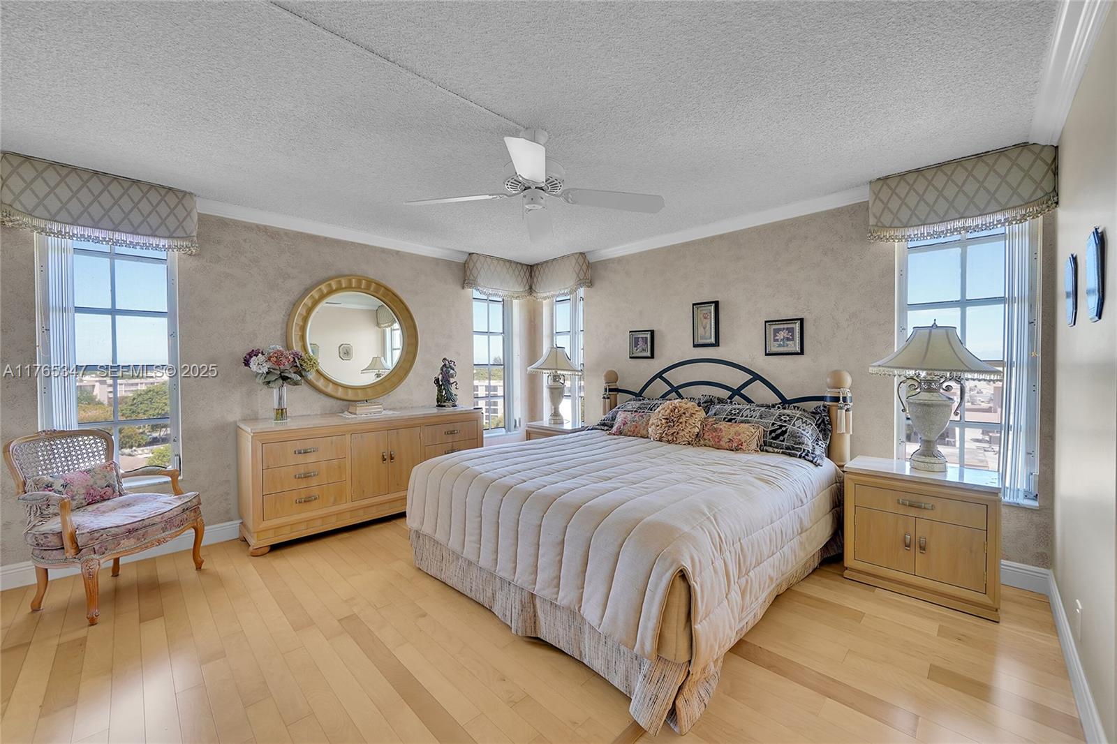 2681 South Course Drive, Unit 912 Pompano Beach, FL 33069 - Photo 17 of 44 a bedroom with a large bed and wooden floor