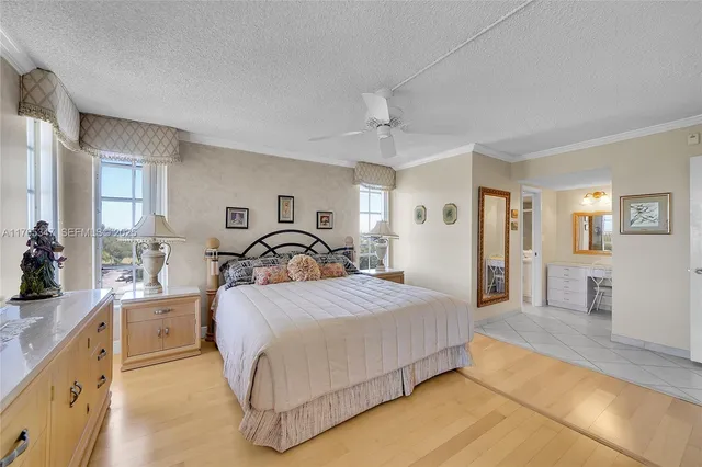 a bedroom with a large bed and wooden floor