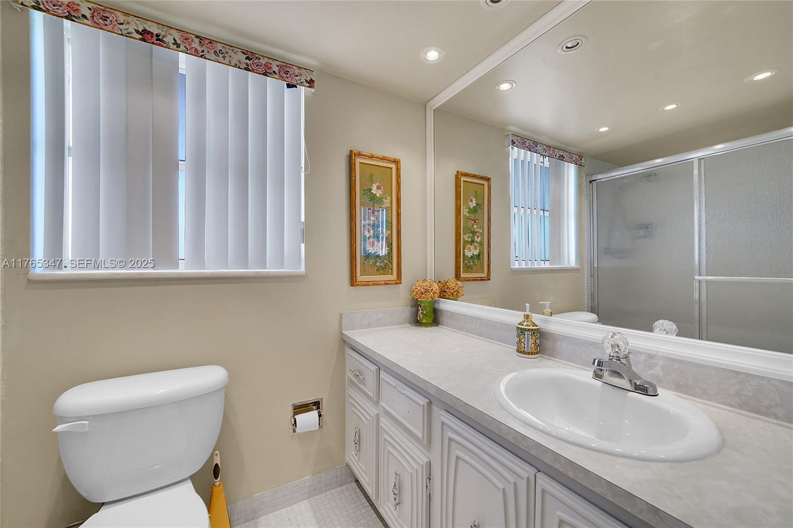2681 South Course Drive, Unit 912 Pompano Beach, FL 33069 - Photo 20 of 44 a bathroom with 2 sink toilet and a mirror