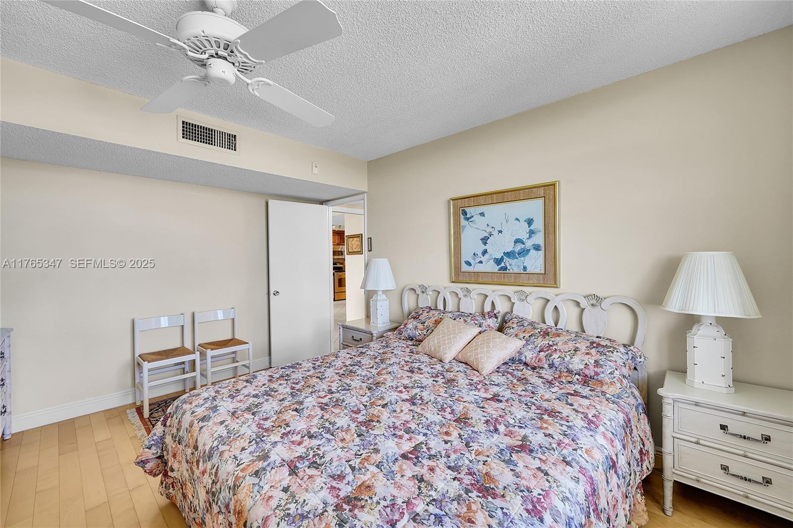 2681 South Course Drive, Unit 912 Pompano Beach, FL 33069 - Photo 22 of 44 a bedroom with a bed and a lamp on dresser