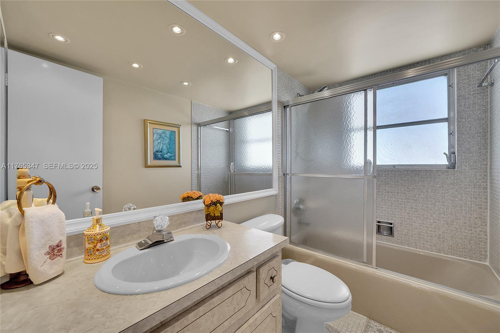 2681 South Course Drive, Unit 912 Pompano Beach, FL 33069 - Photo 23 of 44 a bathroom with a sink toilet tub and shower