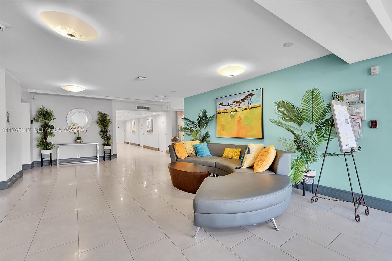 2681 South Course Drive, Unit 912 Pompano Beach, FL 33069 - Photo 27 of 44 a living room with furniture and a flat screen tv