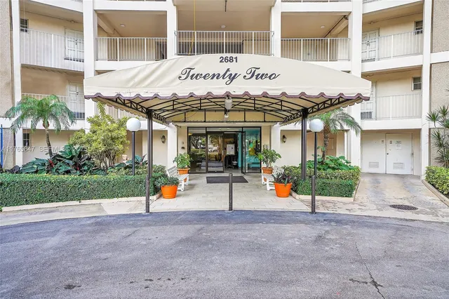 a living room with furniture and floor to ceiling window