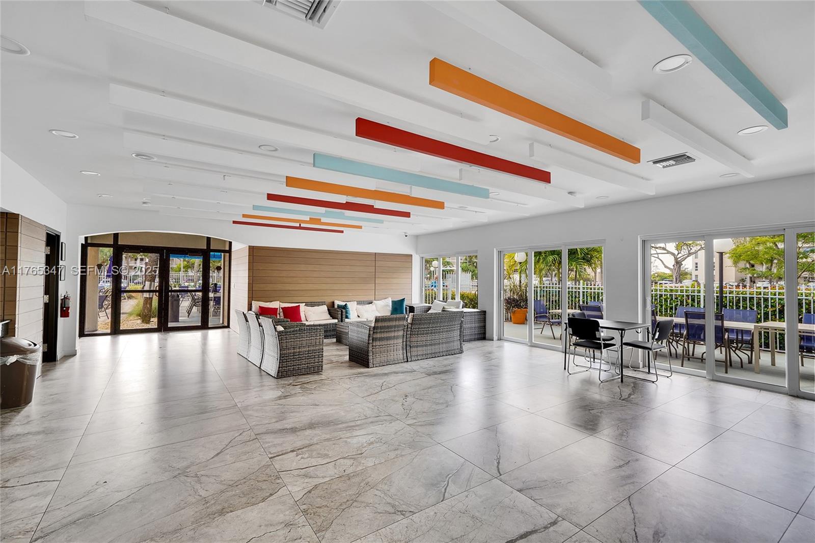 2681 South Course Drive, Unit 912 Pompano Beach, FL 33069 - Photo 29 of 44 a living room with furniture and floor to ceiling window