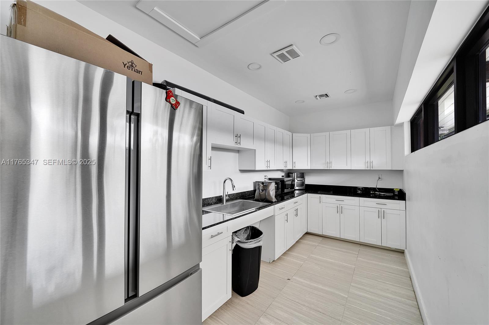2681 South Course Drive, Unit 912 Pompano Beach, FL 33069 - Photo 30 of 44 a kitchen with stainless steel appliances a refrigerator sink and white cabinets