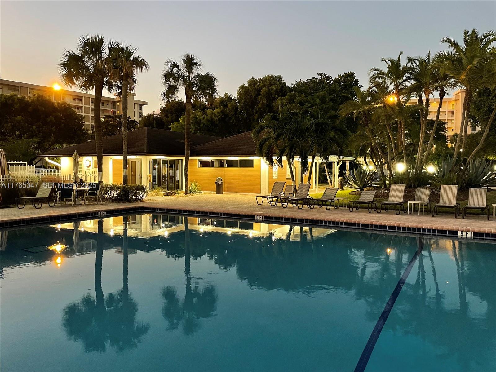 2681 South Course Drive, Unit 912 Pompano Beach, FL 33069 - Photo 31 of 44 a view of swimming pool and an outdoor seating