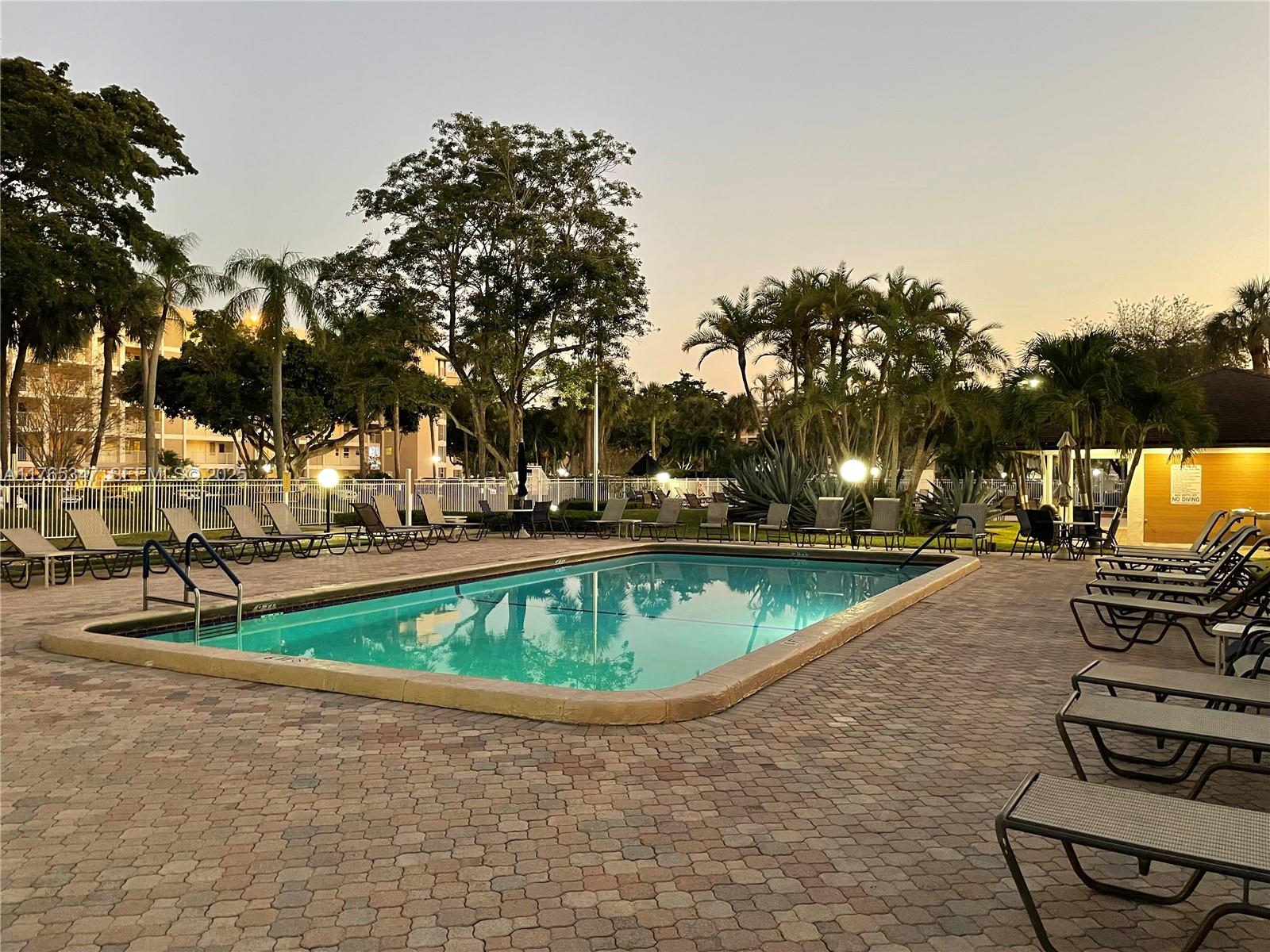 2681 South Course Drive, Unit 912 Pompano Beach, FL 33069 - Photo 35 of 44 a view of a swimming pool with a patio