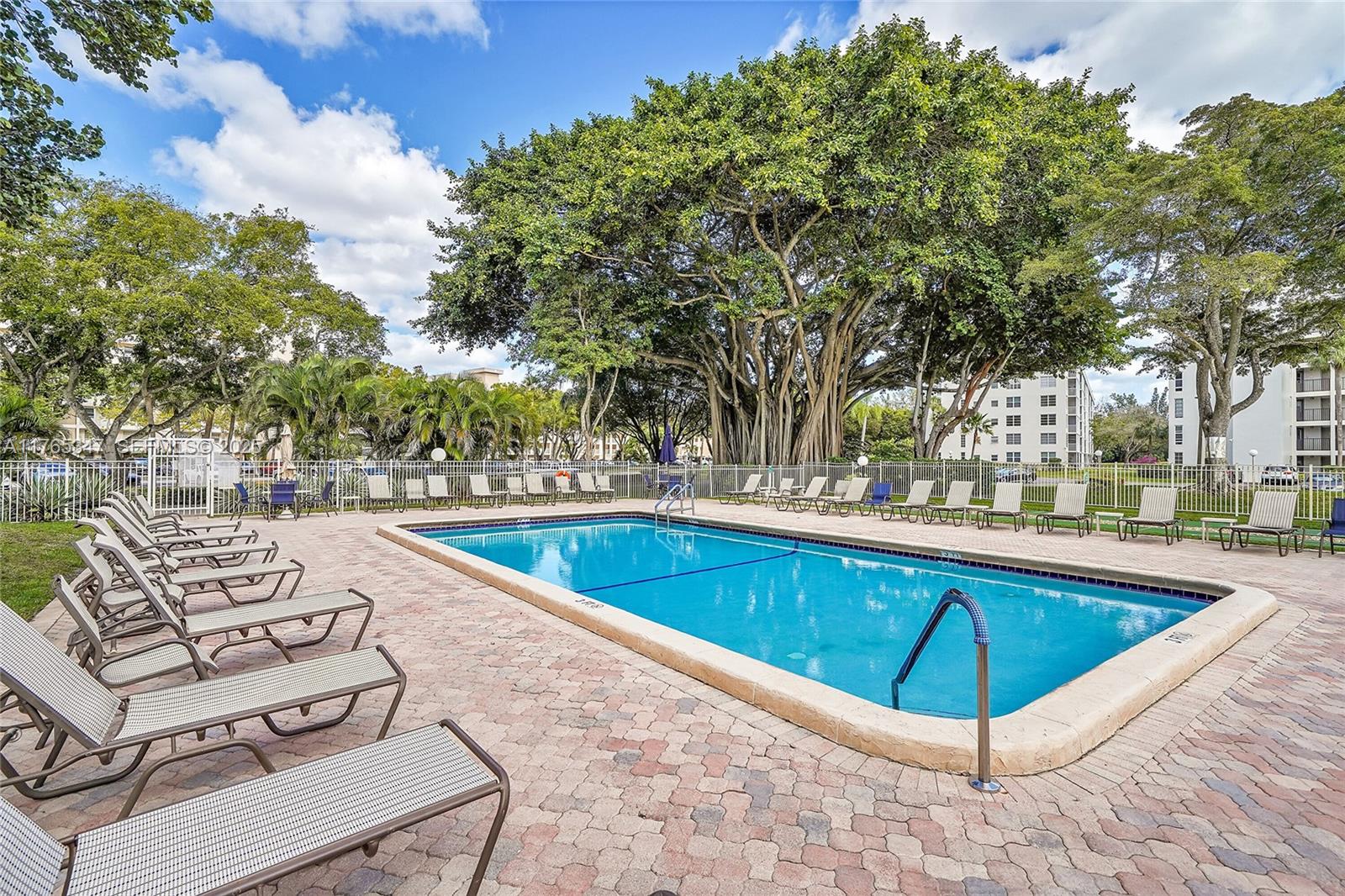 2681 South Course Drive, Unit 912 Pompano Beach, FL 33069 - Photo 37 of 44 a view of a swimming pool with a patio