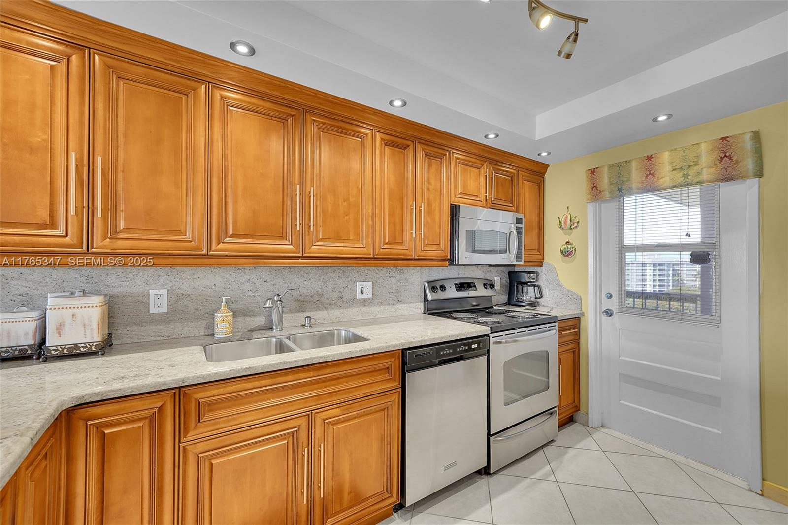 2681 South Course Drive, Unit 912 Pompano Beach, FL 33069 - Photo 6 of 44 a kitchen with stainless steel appliances granite countertop a sink stove and refrigerator
