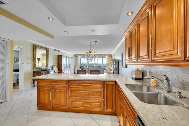 a kitchen with granite countertop a sink and cabinets