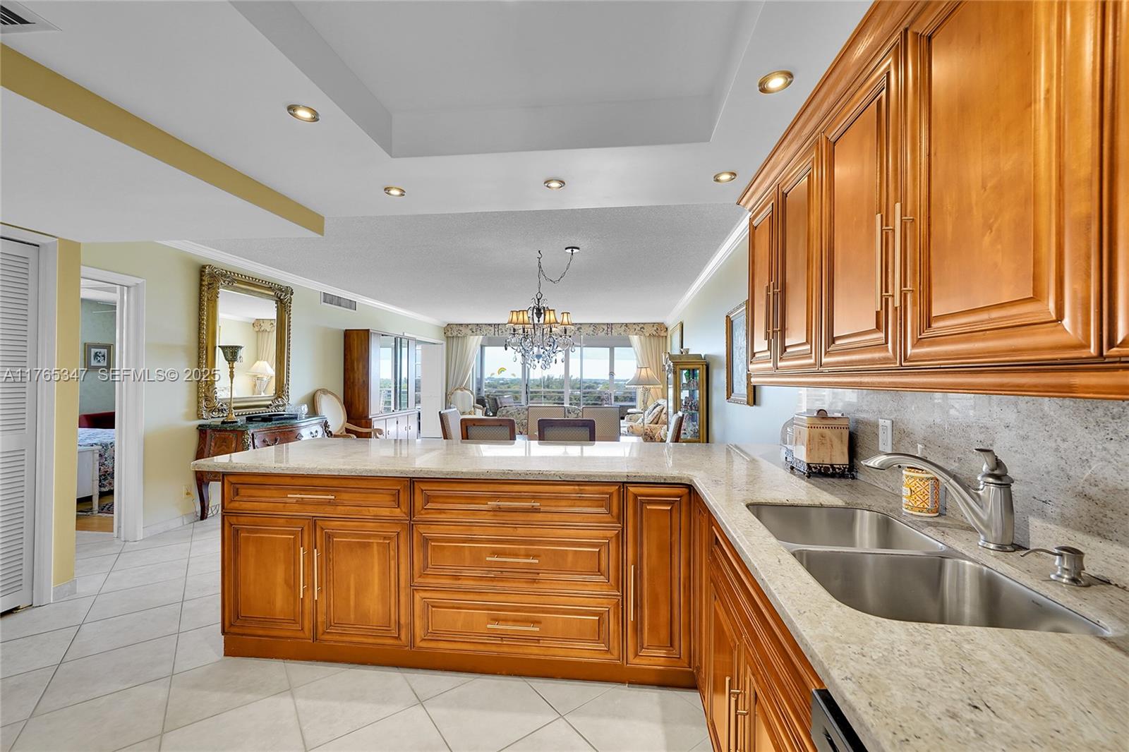 2681 South Course Drive, Unit 912 Pompano Beach, FL 33069 - Photo 8 of 44 a kitchen with granite countertop a sink and cabinets