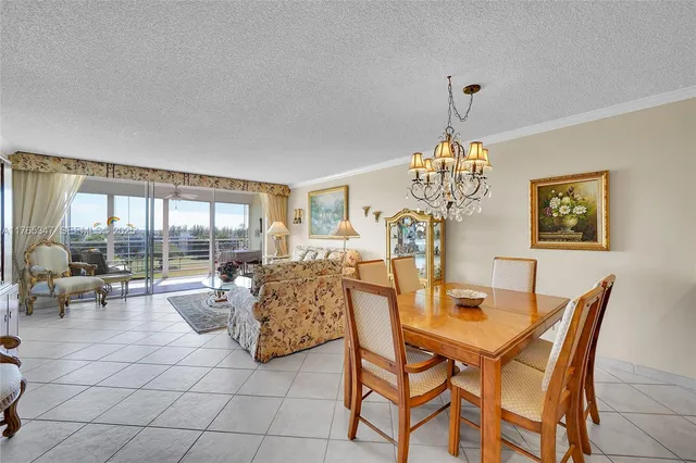 a view of a dining room with furniture wooden floor and a chandelier