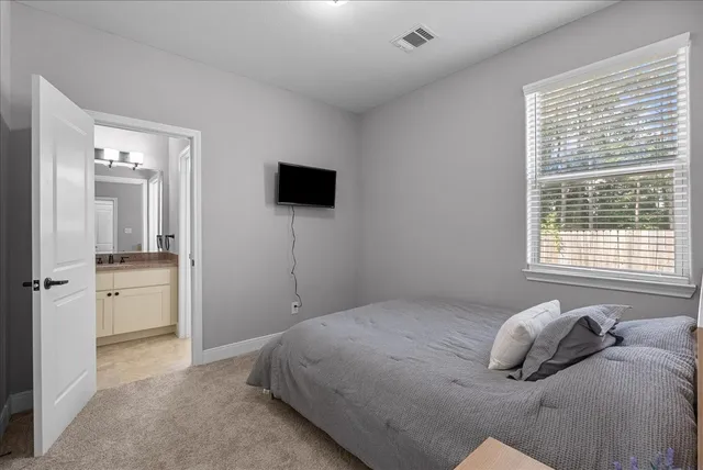 a bedroom with a bed and a flat tv screen
