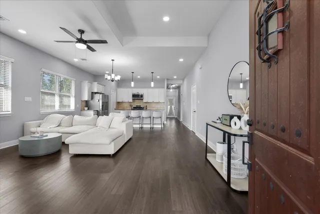a living room with furniture and a wooden floor