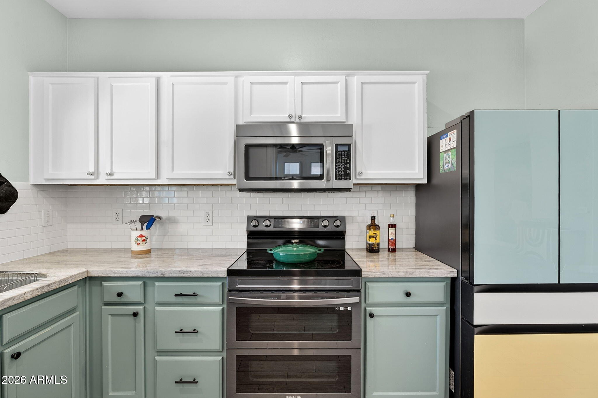 1317 South Banning Street Gilbert, AZ 85296 - Photo 8 of 46 a kitchen with a stove and a microwave