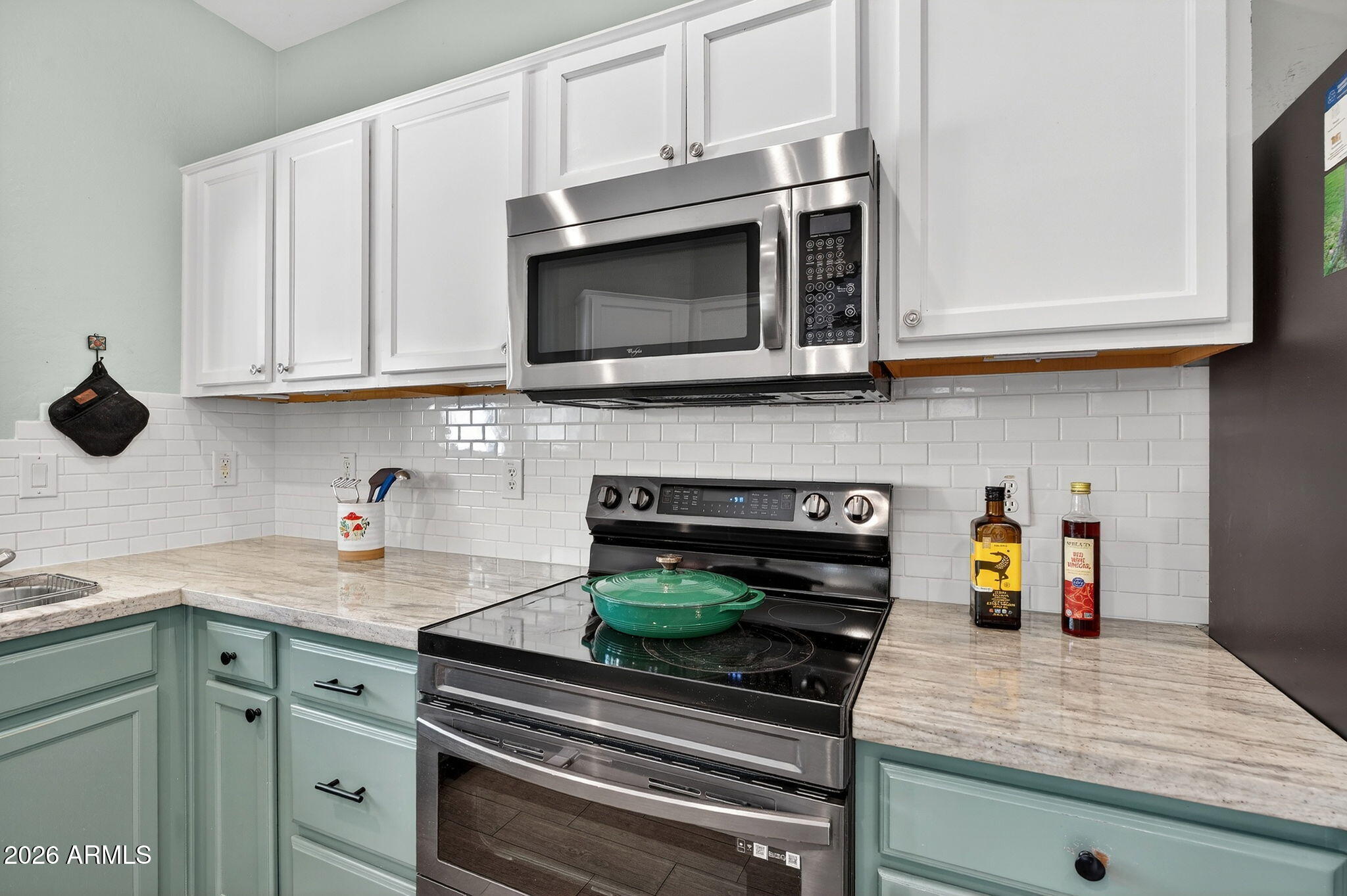 1317 South Banning Street Gilbert, AZ 85296 - Photo 9 of 46 a kitchen with stainless steel appliances granite countertop a stove and a microwave