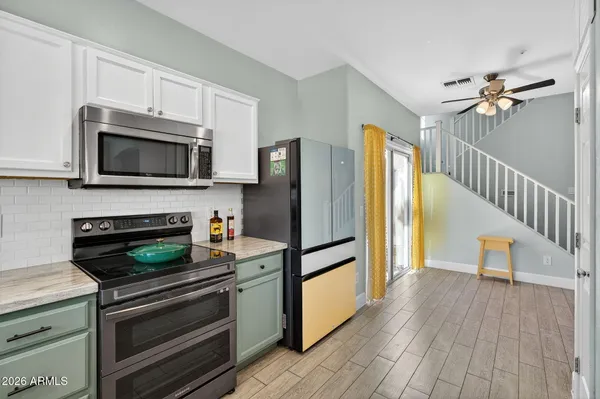 a kitchen with stainless steel appliances granite countertop a stove and a microwave