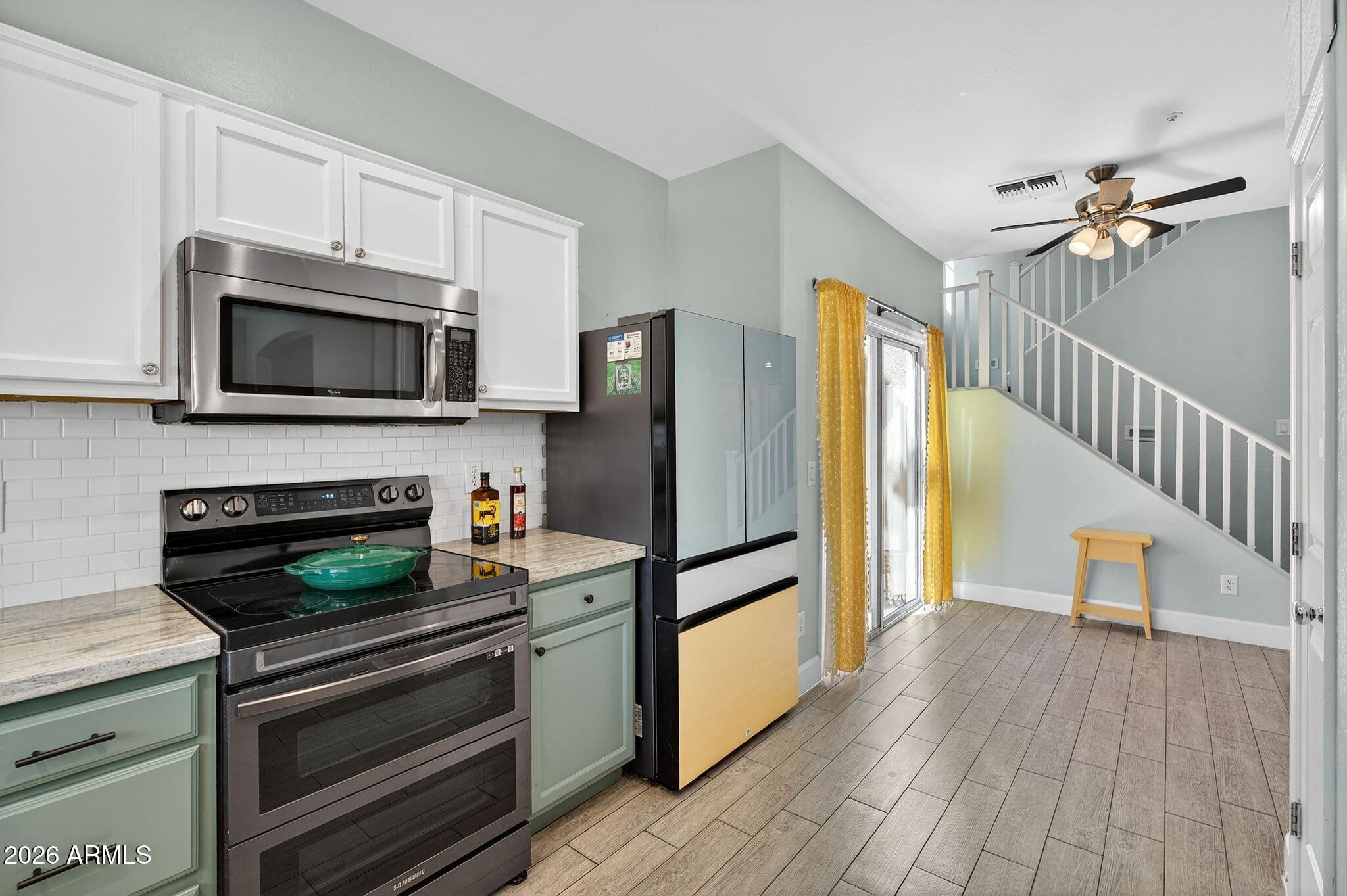1317 South Banning Street Gilbert, AZ 85296 - Photo 11 of 46 a kitchen with granite countertop a refrigerator and a stove top oven