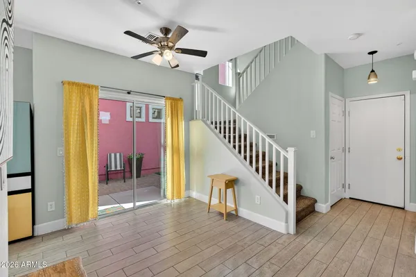 a kitchen with granite countertop a refrigerator and a stove top oven
