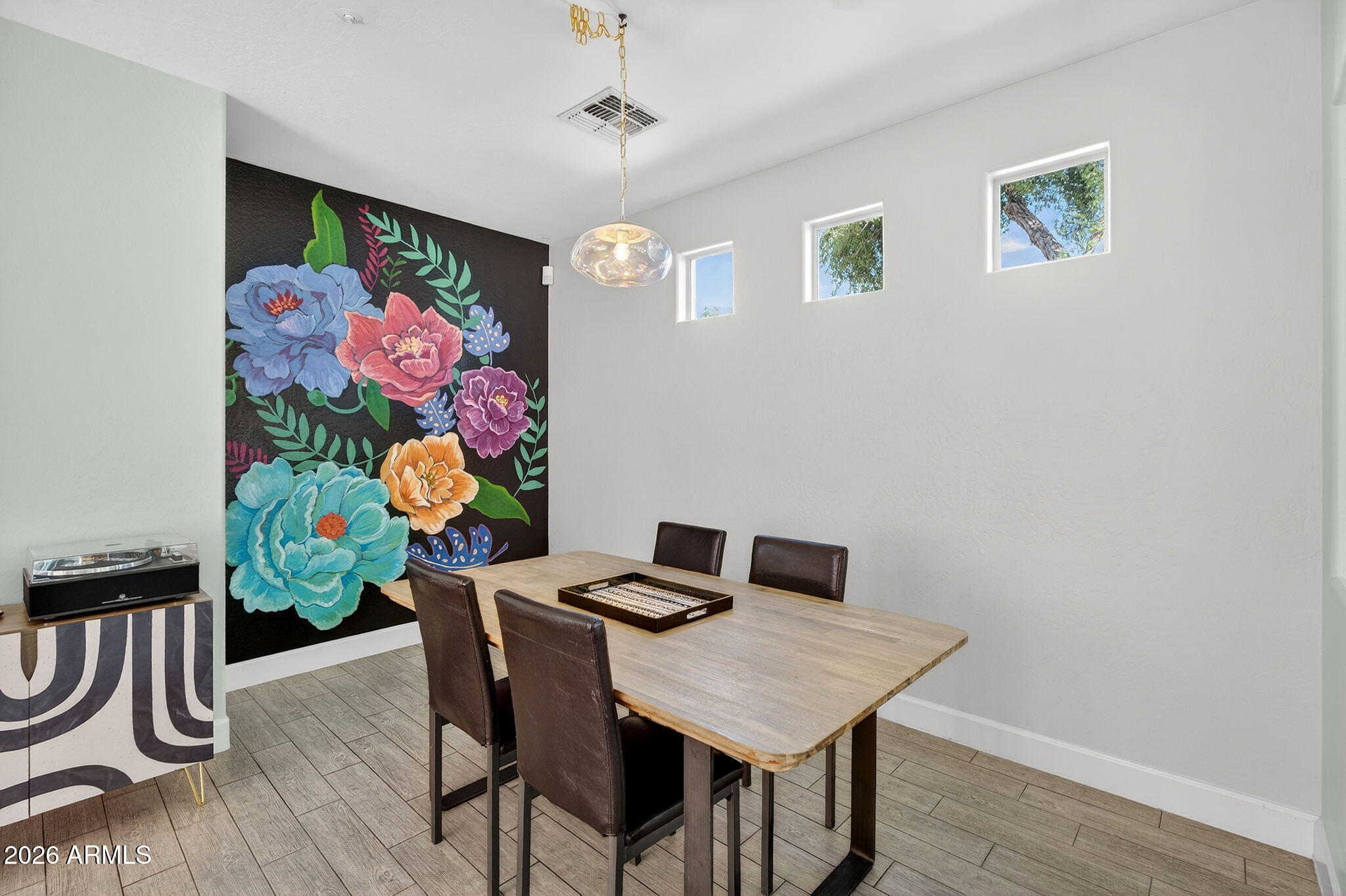 1317 South Banning Street Gilbert, AZ 85296 - Photo 13 of 46 a view of a dining room with furniture and wooden floor