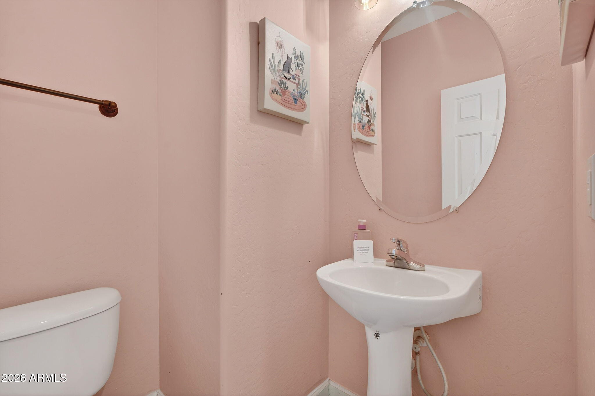 1317 South Banning Street Gilbert, AZ 85296 - Photo 14 of 46 a bathroom with a toilet sink and mirror