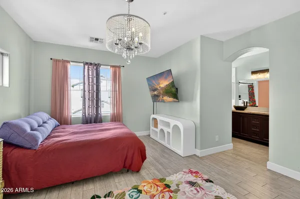 a bedroom with a bed and wooden floor