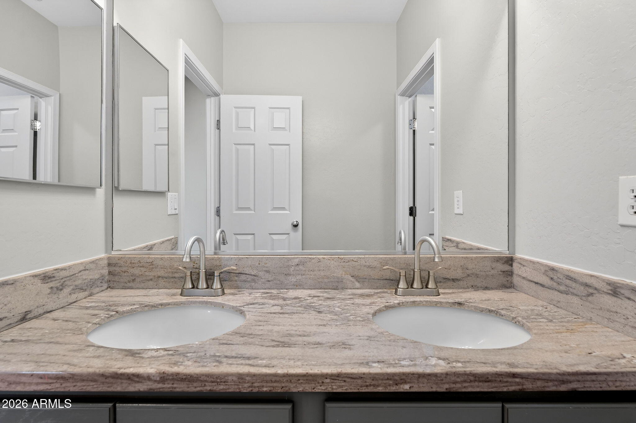 1317 South Banning Street Gilbert, AZ 85296 - Photo 27 of 46 a bathroom with double vanity sinks and a mirror