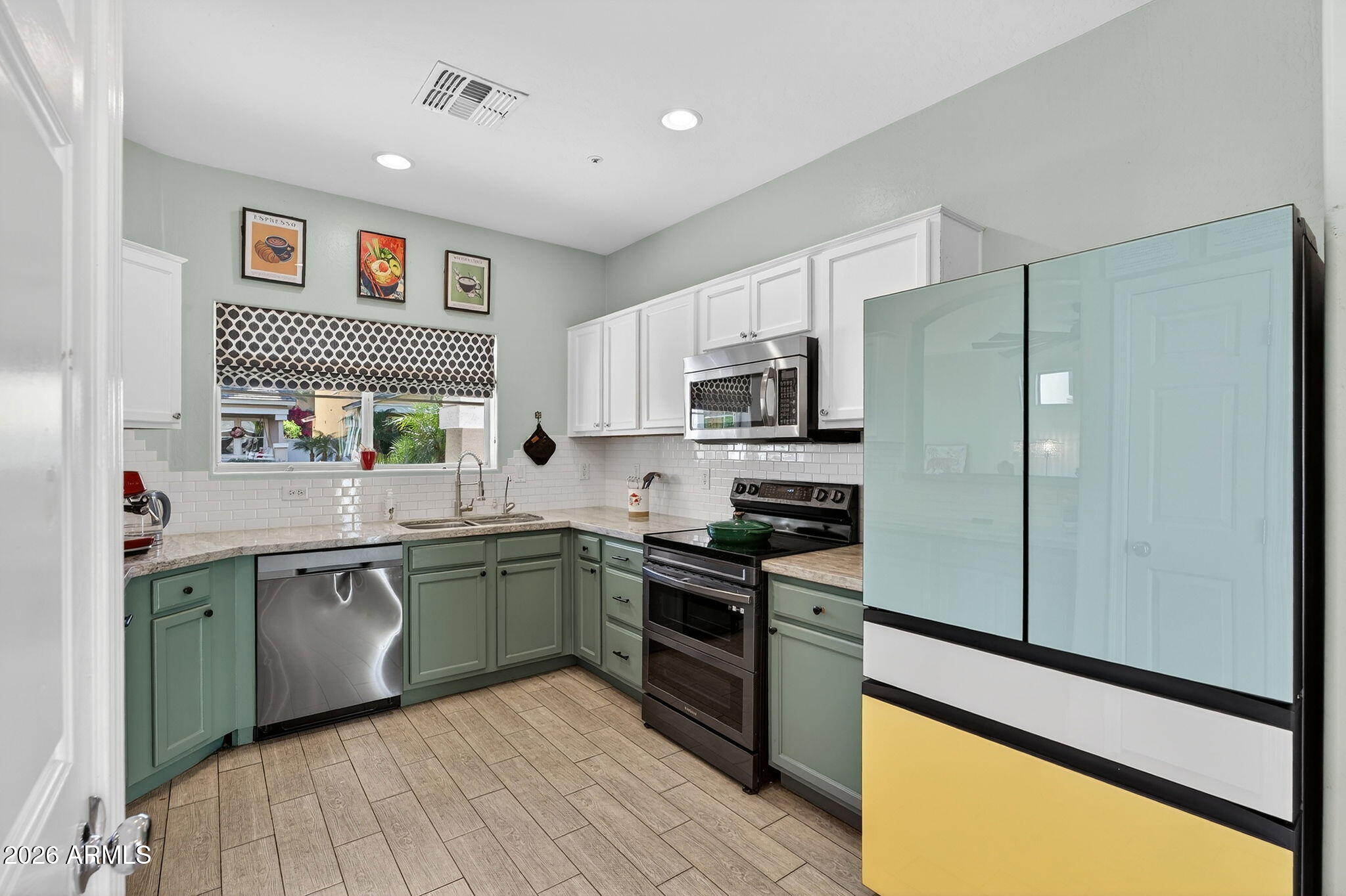 1317 South Banning Street Gilbert, AZ 85296 - Photo 6 of 46 a kitchen with stainless steel appliances granite countertop refrigerator a sink dishwasher a stove top oven a refrigerator with island and chairs