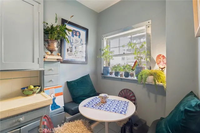 a view of a dining room with furniture and a potted plant