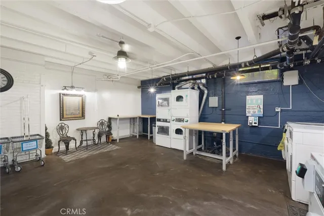 a view of a room with lots of furniture and a chandelier