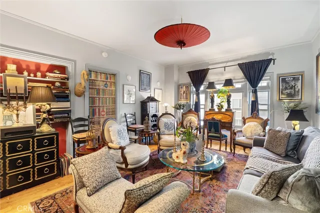 a living room with furniture a flat screen tv and wooden floor