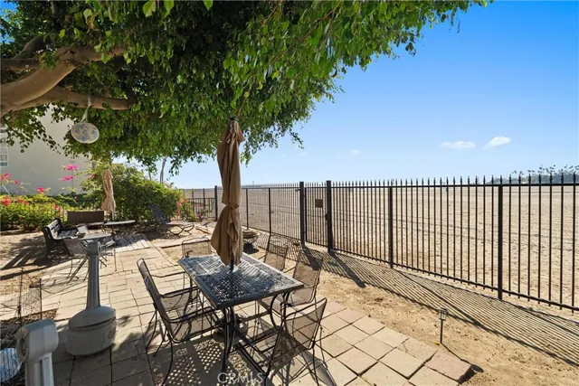 a view of a chairs and table in patio with wooden fence