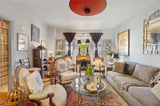 a living room with furniture kitchen view and a large window