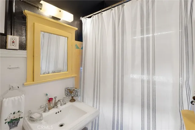 a bathroom with a sink a mirror and a shower