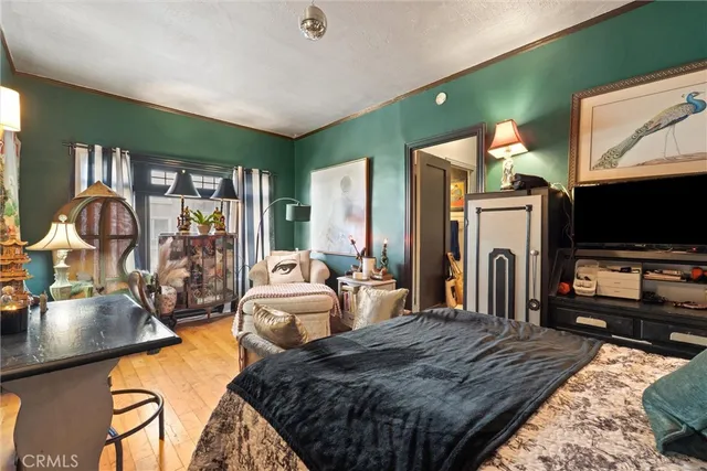 a bedroom with a bed and flat screen tv