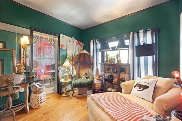 a bedroom with furniture and a large window