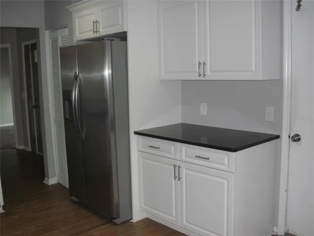 a kitchen with granite countertop a stove and a microwave
