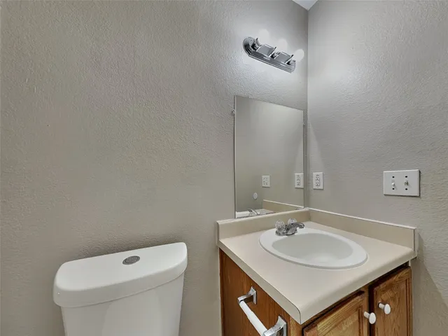a bathroom with a sink toilet and mirror
