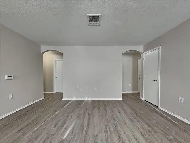 a view of a room with wooden floor