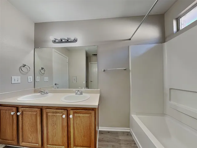 a bathroom with a sink a mirror and a bathtub