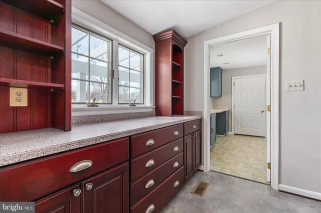 a front view of a house with a garden and trees